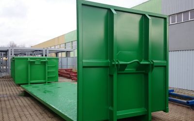 Zwei grüne Abrollplattformen für den Transport vorbereitet - nachhaltige Lösung für effiziente Logistik